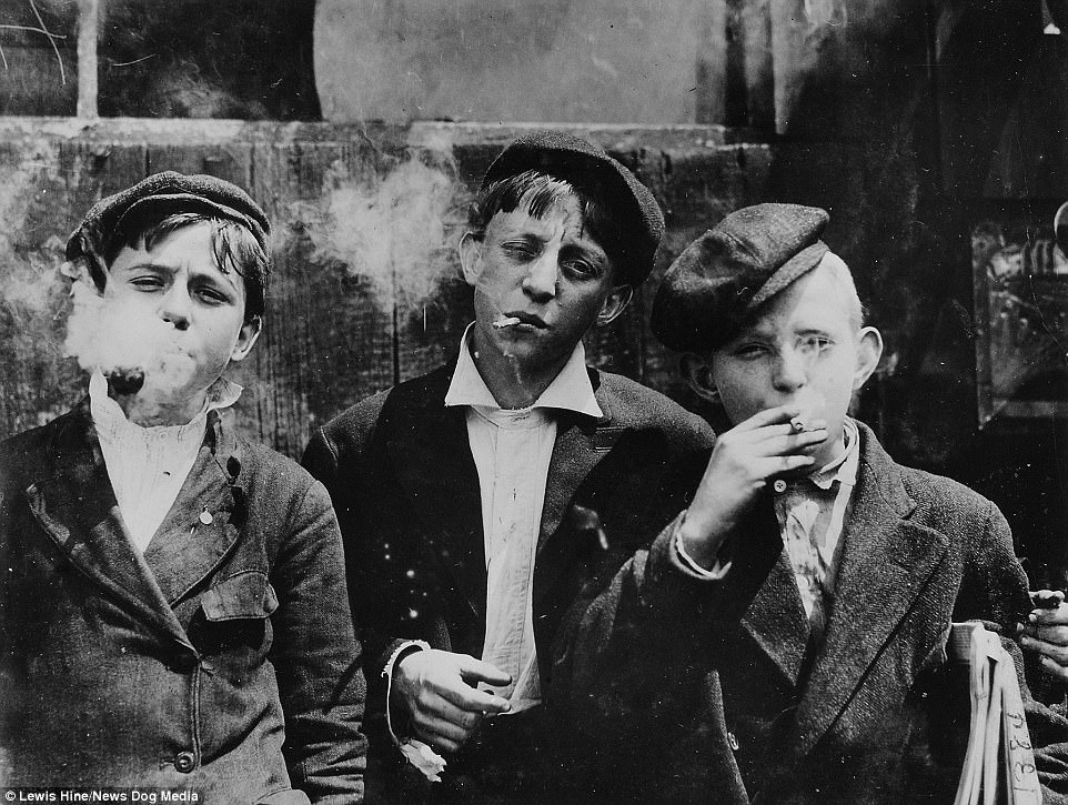 Teenage boys line up to smoke a cigarette in St. Louis, Missouri, 1910