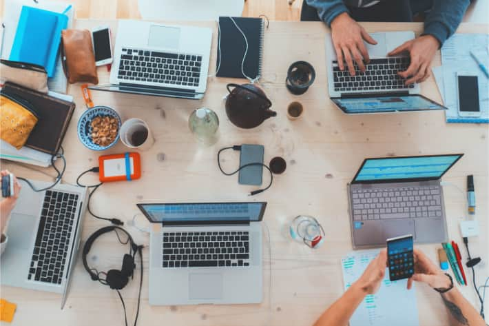 Group of people using laptops and mobile devices